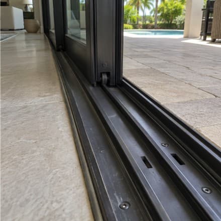 Clean interior glass sliders looking out to a lanai